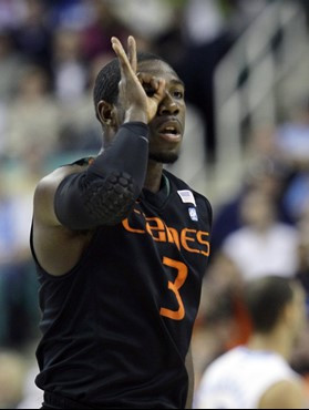 Miami's Malcolm Grant (3) reacts after making a 3-point shot against North Carolina in the first half of an NCAA college basketball game at the...