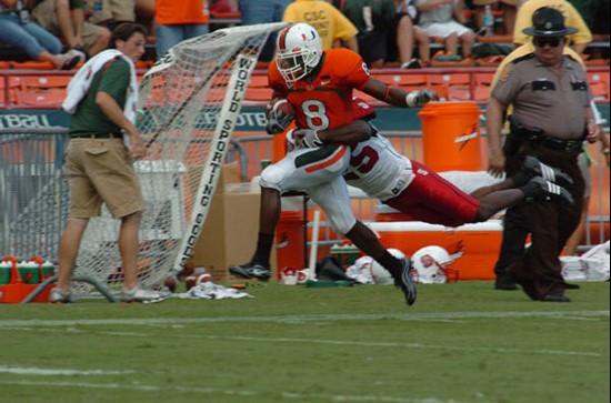 University of Miami wide receiver Darnell Jenkins #8 catches a pass from quarterback Kirby Freeman #7 in a game against the North Carolina State...