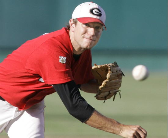 Georgia starting pitcher Trevor Holder delivers against Miami in the second inning of an NCAA College World Series baseball game, in Omaha, Neb.,...