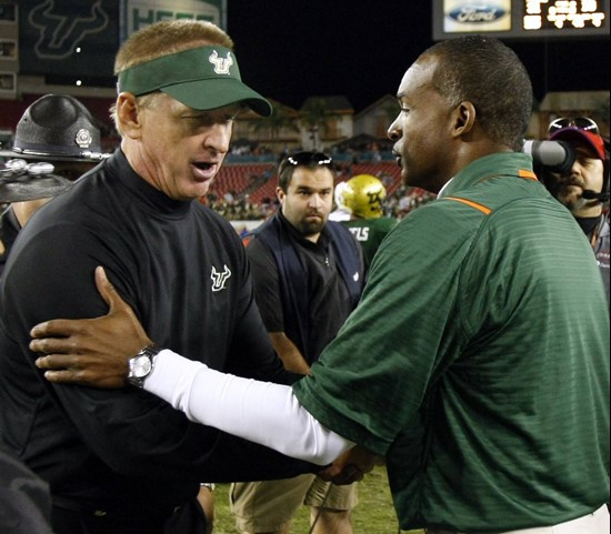 Miami head coach Randy Shannon, right, shakes hands with South Florida head coach Jim Leavitt after Miami defeated South Florida 31-10 in an NCAA...