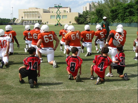 The Kendall Hammocks stretch with the Mimai Football Team during training camp