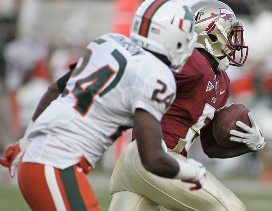 Florida State cornerback Greg Reid, right rear, takes off past Miami defensive back Davon Johnson (24) on an 83-yard punt return for a touchdown...