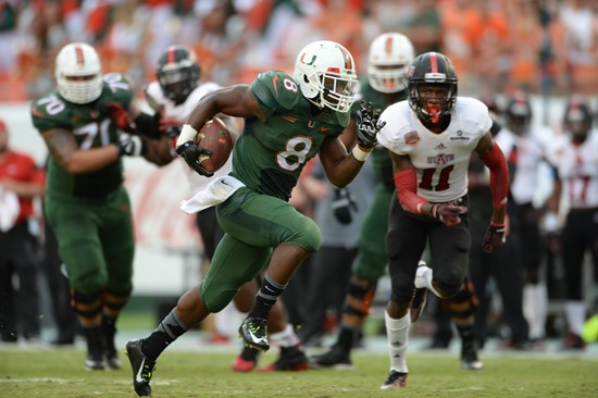 University of Miami Hurricanes running back Duke Johnson #8 catches a deflected pass in a game against the Arkansas State Red Wolves at Sun Life...