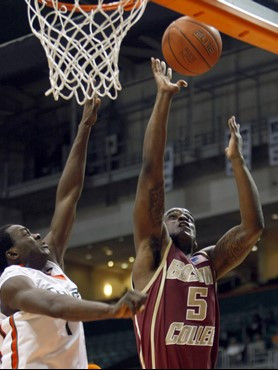 Boston College's Bike Paris (5) is fouled by Miami's Durand Scott in the first half of a NCAA college basketball game in Coral Gables, Fla., Tuesday,...