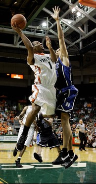 Lance Hurdle (1) prepares to shoot to the basket as Duke's David McClure, right, defends in the first half of a basketball game in Coral Gables, Fla.,...