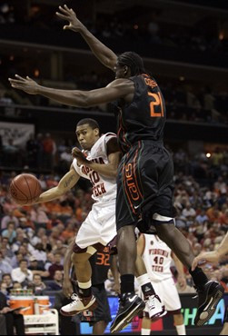 Virginia Tech's Hank Thorns looks to pass around Dwayne Collins in the first half. (AP Photo/Steve Helber)