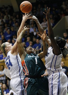 Duke's Kathleen Scheer (24) and Elizabeth Williams, right, block Miami's Riquna Williams (1) during the second half. (AP Photo/Gerry Broome)