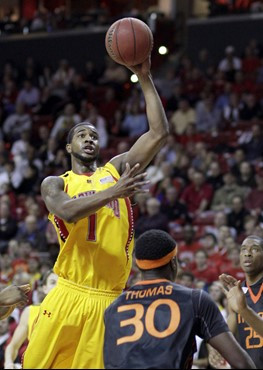 Maryland's Landon Milbourne (1) puts up a shot over Miami's Adrian Thomas (30) during the first half. (AP Photo/Rob Carr)