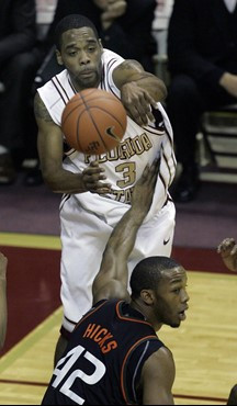 Florida State's Isaiah Swann, top, goes over Miami's Raymond Hicks to make a first-half pass during a college basketball game, Saturday, Jan. 20,...