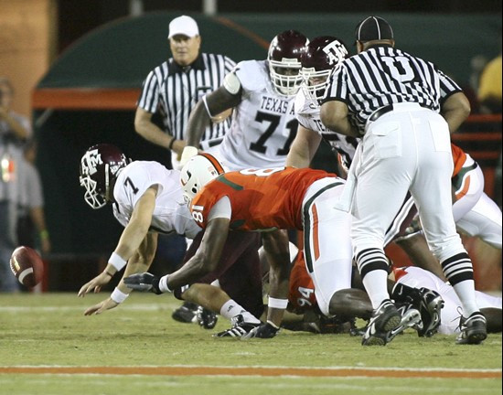 Texas A&M quarterback Stephen McGee loses the football as Miami defensive end Calais Campbell applies pressure in the second quarter. (AP Photo/Luis...