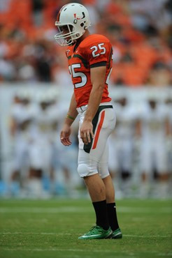 University of Miami Hurricanes kicker/punter Matt Bosher #25 kicks in a game against the University of Central Florida Knights at Dolphin Stadium on...