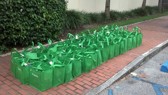 Seven football players and other staff delivered 48 turkey dinners to the Greater Mercy Missionary Baptist Church in Overtown.