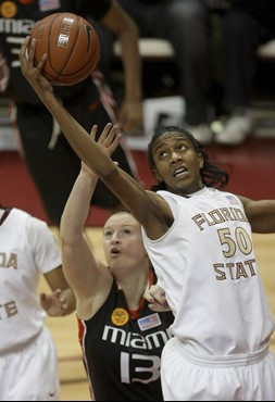 Florida State's Jacinta Monroe pulls down a second-half rebound over Miami's Hannah Shaw during an NCAA college basketball game, Thursday, Feb. 25,...