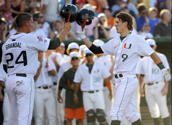 Miami's Blake Tekotte, right, is greeted by teammate Yasmani Grandal, after Tekotte hit a two-run home run against Georgia in the third inning of an...