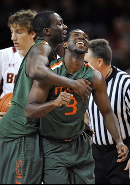 Miami's Malcolm Grant (3) and Durand Scott celebrate a foul call against Boston College in the final seconds of an NCAA college basketball game in...