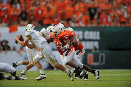 University of Miami Hurricanes linebacker Darryl Sharpton #50 puts pressure on quarterback in a game against the University of Central Florida Knights...