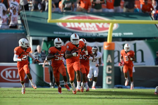 Defensive lineman David Gilbert #11 and The University of Miami Hurricanes plays in a game against the Virginia Cavaliers at Sun Life Stadium on...