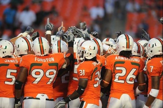 University of Miami Hurricane players meet at the 50 yard line in a sign of unity before a game against the Georgia Tech Yellow Jackets at Land Shark...