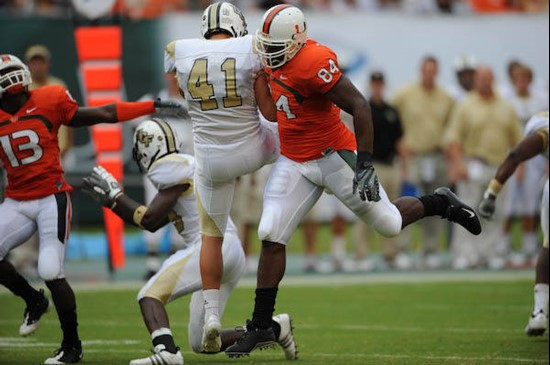 University of Miami Hurricanes tight end Richard Gordon #84 tackles in a game against the University of Central Florida Knights at Dolphin Stadium on...