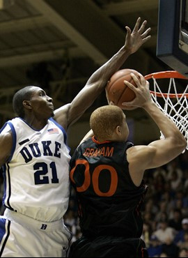 Duke's DeMarcus Nelson (21) blocks Miami's Jimmy Graham (0) during the second half of a college basketball game in Durham, N.C., Saturday, Feb. 2,...