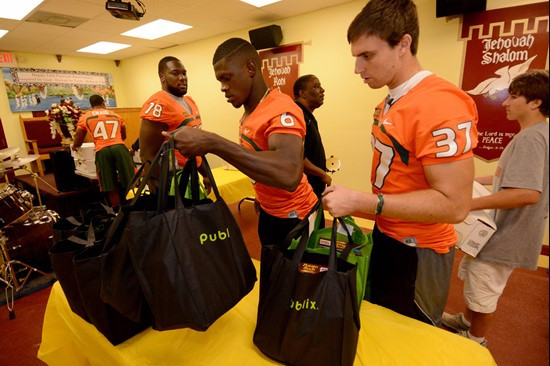 Herb Waters and Alex Irastorza unload bags of food Tuesday in Overtown.