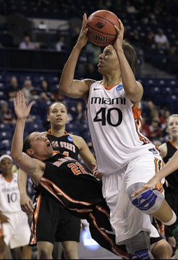 Miami's Shawnice Wilson (40) shoots as Idaho State's Ashleigh Vella tumbles backwards in the second half of an NCAA tournament first-round women's...