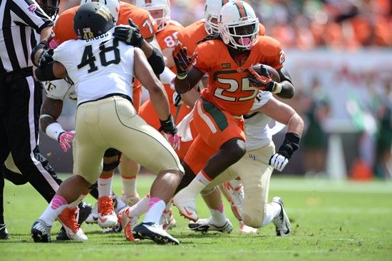 University of Miami Hurricanes running back Dallas Crawford #25 carries the ball in a game against the Wake Forest Demon Deacons at Sun Life Stadium...