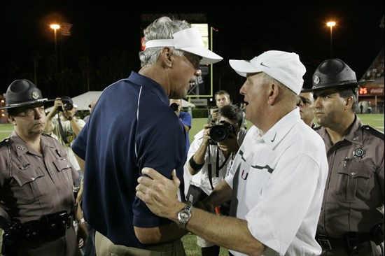 Florida International coach Don Strock, left, and Miami coach Larry Coker talk after Miami's 35-0 victory over Florida International in Miami,...