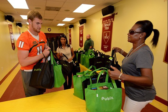 Ryan Williams and Diona Kehoe unload bags Tuesday in Overtown.