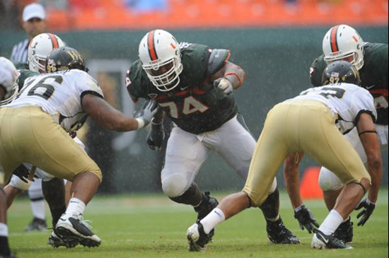University of Miami Hurricanes offensive lineman Orlando Franklin #74 gets set to throw a block against the Deamon Deacons of Wake Forest at Dolphin...