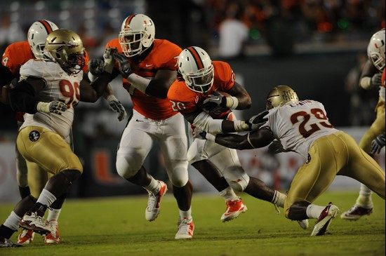 University of Miami Hurricanes running back Damien Berry #20 carries the ball against the Florida State Seminoles at Sun Life Stadium on October 9,...