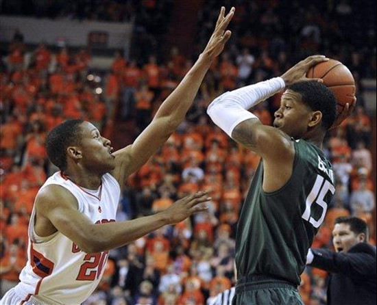 Miami's Rion Brown (15) looks to pass as Clemson's Jordan Roper (20) defends in the first half of an NCAA college basketball game, Sunday, Feb. 17,...