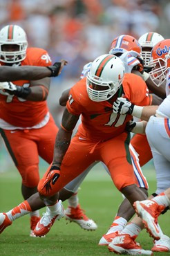 Defensive lineman David Gilbert #11 and The University of Miami Hurricanes plays in a game against the #12 ranked University of Florida Gators at Sun...