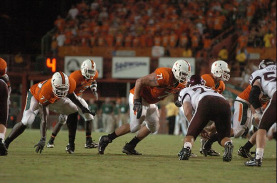 University of Miami offensive lineman Derrick Morse #71 and Reggie Youngblood #77 get set to block in a game against the Texas A&M Aggies at the...