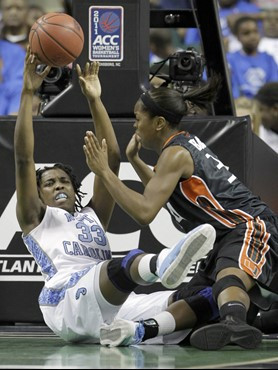 North Carolina's Laura Broomfield (33) saves the ball as Miami's Sylvia Bullock (34) defends in the first half of an NCAA college basketball game at...