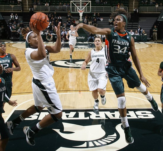 Michigan State's Porsche Poole, left, puts up a shot against Miami's Sylvia Bullock (34) during the first half. (AP Photo/Al Goldis)