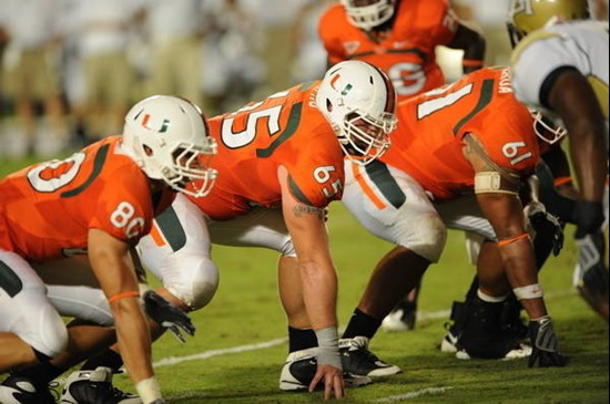 University of Miami Hurricanes wide receiver Chris Hayes #80 and offensive lineman Matt Pipho #65 setup at the line of scrimmage in a game against the...