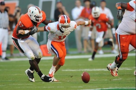 University of Miami Hurricanes defensive lineman Allen Bailey #57 causing a fumble in a game against the Clemson Tigers at Land Shark Stadium on...