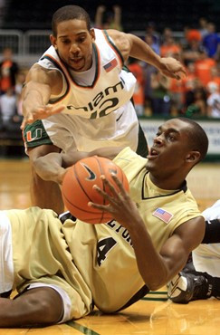 Wake Forest's Harvey Hale (4) tries to throw a pass from the floor as Miami's Anthony Harris, top, defends during the first half of a basketball game...