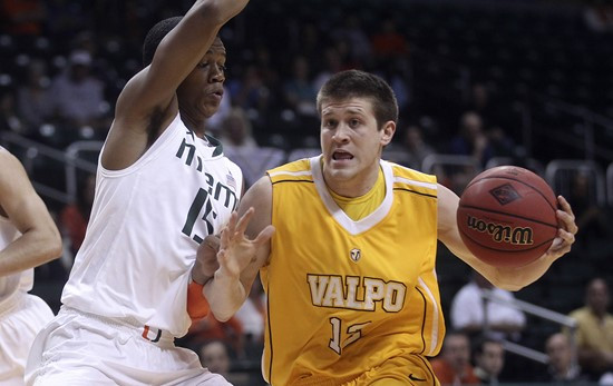 Miami's Rion Brown (15) forces Valparaiso's Ben Boggs (12) to pass the ball off during the first half. (AP Photo/J Pat Carter)