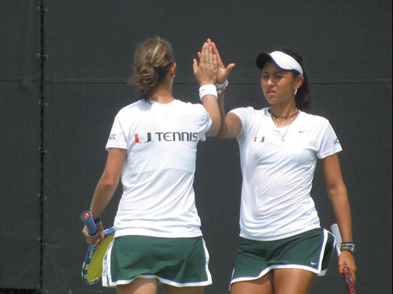 Gabriela Mejia (L) and Kayla Rizzolo (R) celebrate after winning a point Saturday at the Neil Schiff Tennis Center.