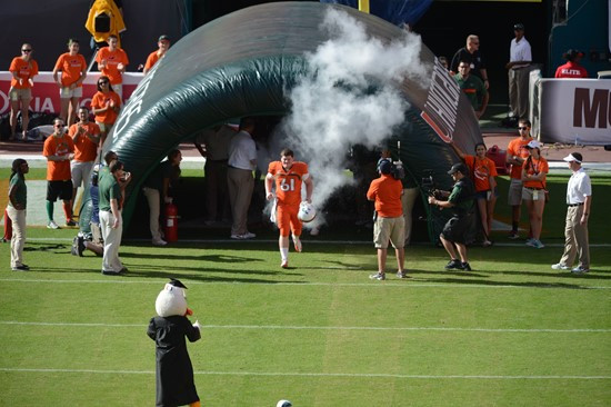 Sebastian the Ibis leads the University of Miami Hurricanes through a tunnel of smoke in a game against the University of South Florida Bulls at Sun...