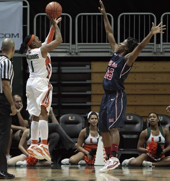Miami's Riquna Williams (1) shoots for three points as Mississippi's Courtney Marbra (25) defends in the second half. (AP Photo/Alan Diaz)