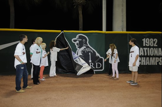 Members of the Fraser family, including his wife Karen, three daughters and five grandchildren, help unveil the new outfield banner commemorating...