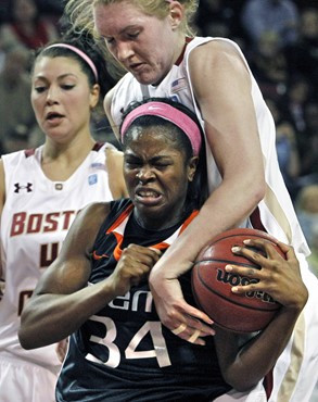 Miami's Sylvia Bullock (34) fights for control of the ball against Boston College's Carolyn Swords as Katie Zenevitch, left, looks on during the first...