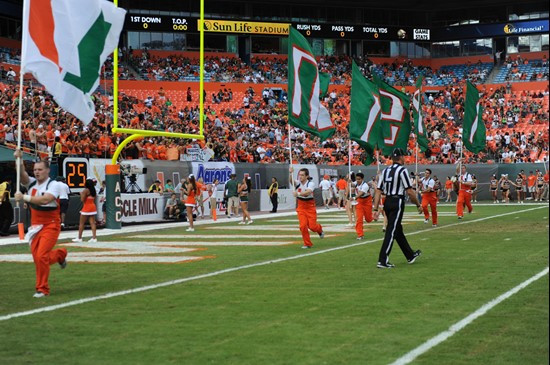 University of Miami Hurricanes fans celebrate after the Canes score a touchdown in a game against the Boston College Eagles at Sun Life Stadium on...