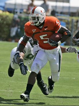 Miami running back Javarris James (5) is tackled by Marshall defensive end Ryland Wilson during the first quarter of a football game Saturday, Sept....