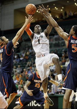 Miami's Durand Scott drives to the hoop against the defense of Virginia during an NCAA college basketball game on Tuesday, Feb. 23, 2010 in Coral...