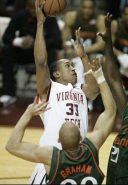 Virginia Tech's Coleman Collins (33) shoots over Miami's Dwayne Collins and Jimmy Graham (00) in the first half a basketball game in Blacksburg, Va.,...