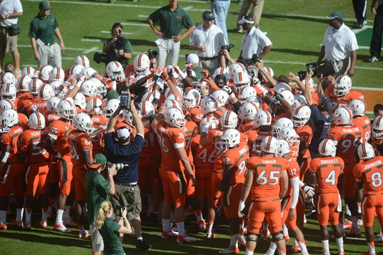 University of Miami Hurricane players meet at the 50 yard line in a sign of unity before a game against the University of South Florida Bulls at Sun...